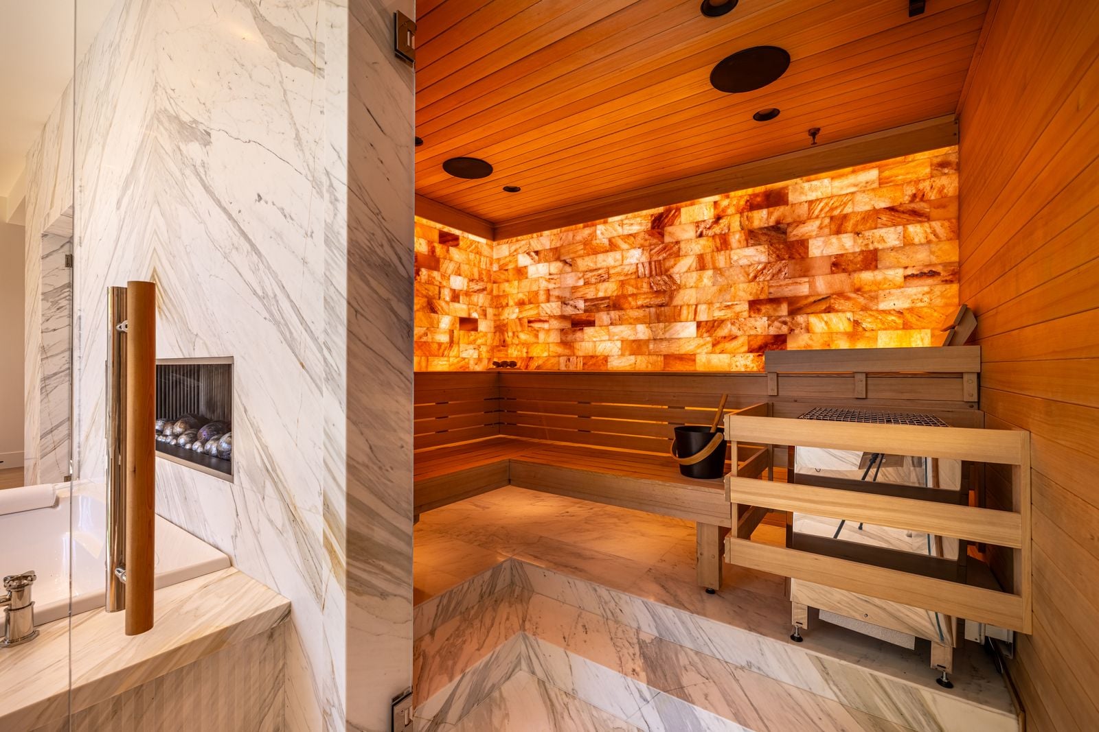 Custom sauna with Himalayan salt wall and L-shaped wood bench