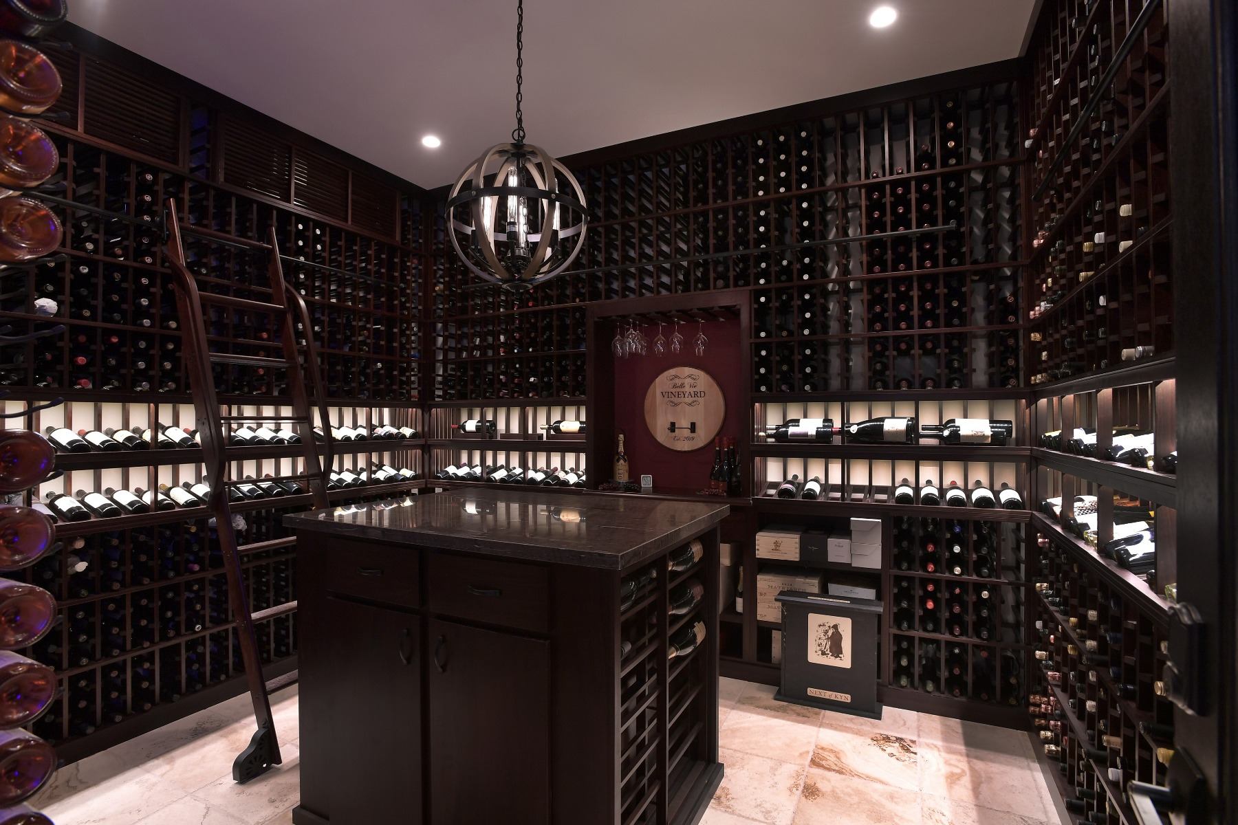 An island in the middle of the room acts as a great spot to open and decant wines