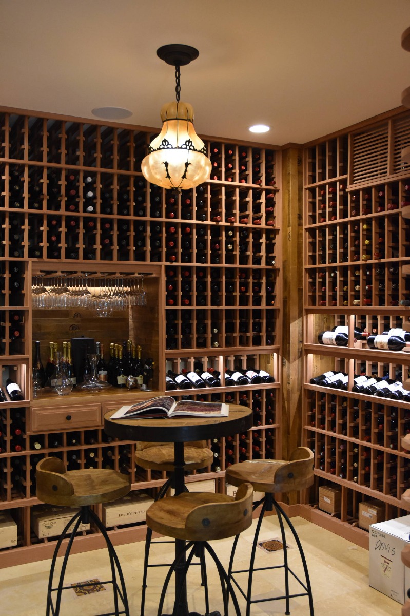 Large walk in custom wine cellar in all heart redwood wine racking utilizing double deep, individual bottle storage
