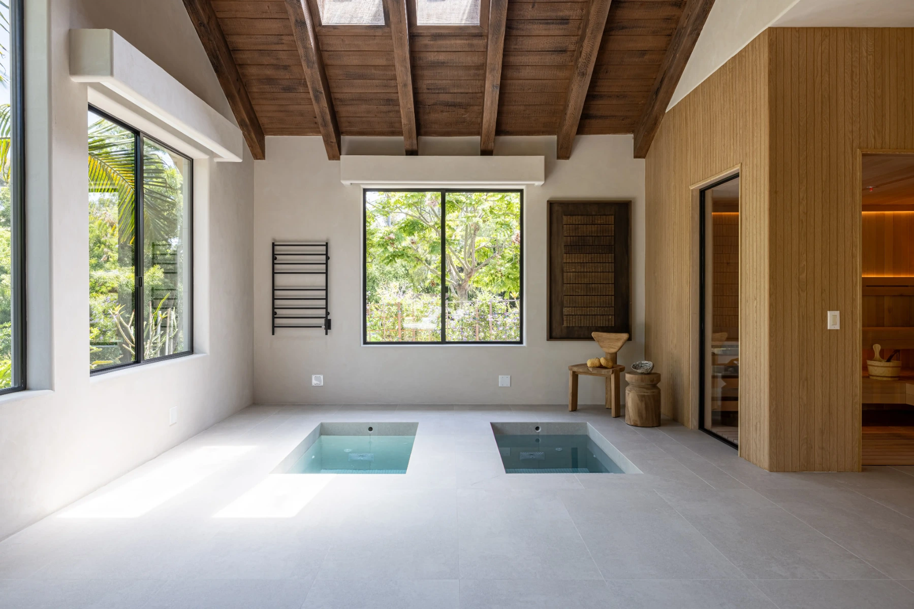 Luxury wellness room featuring a custom sauna and dual cold plunge tubs designed for contrast therapy, relaxation, recovery, and year-round home wellness.