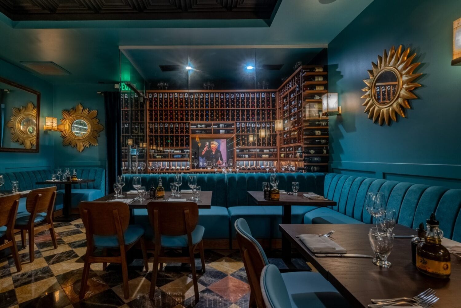 Custom high-capacity wine cellar in Newport Beach with acrylic racking, floating stairway, and dramatic backlighting.