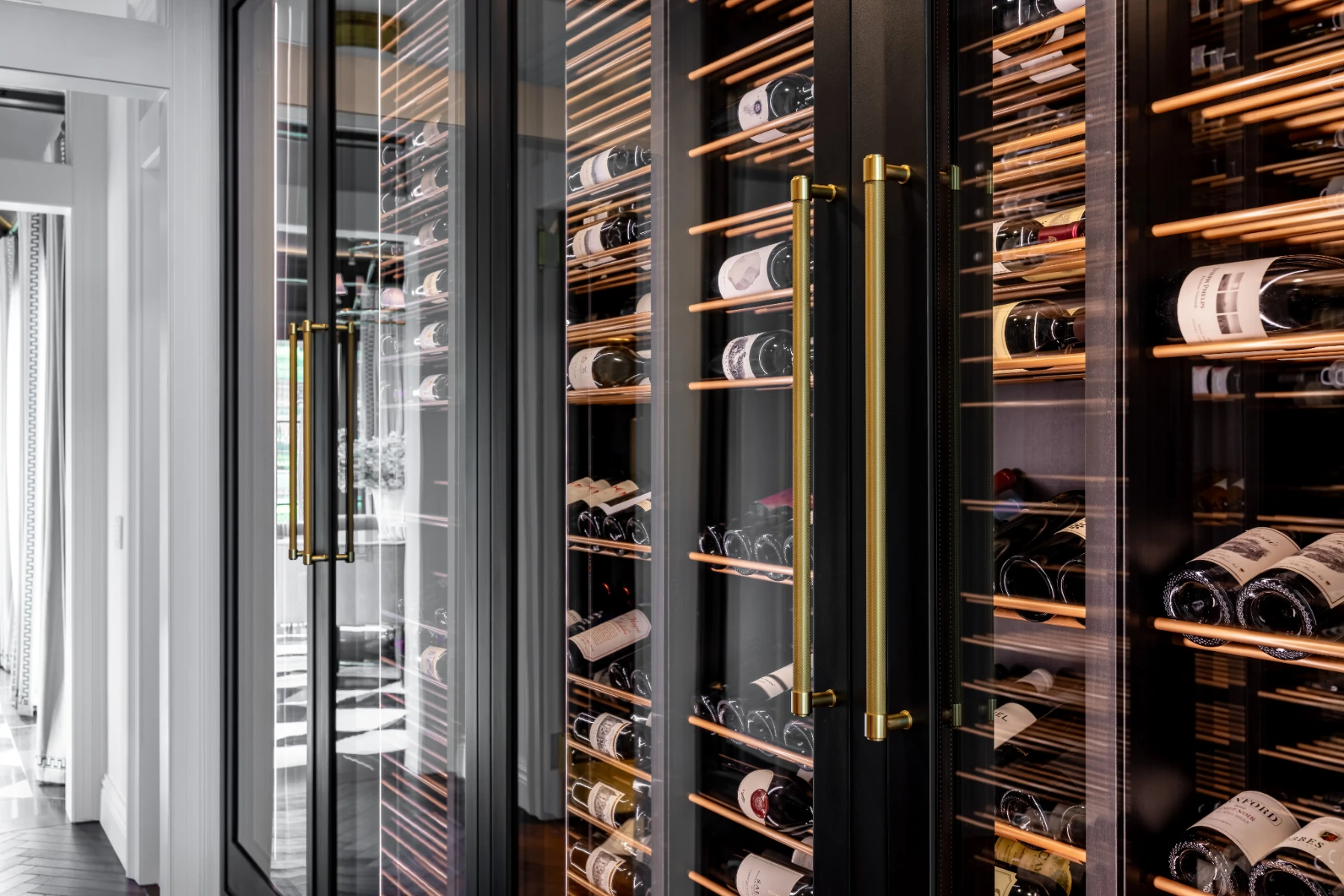 Custom black alder wine cellar doors with gold-toned handles