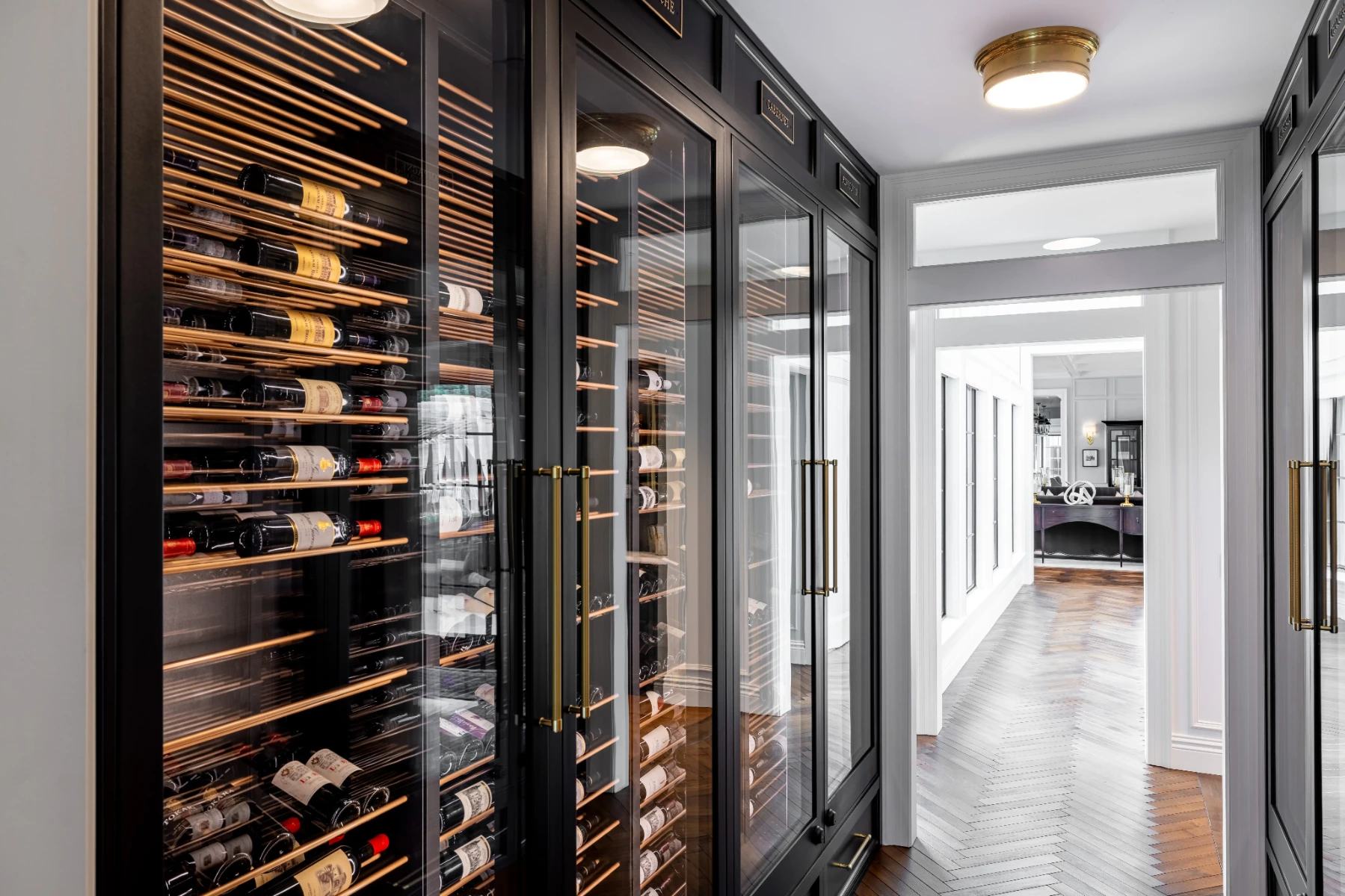 Angled view of custom wine walls in a La Jolla hallway wine cellar