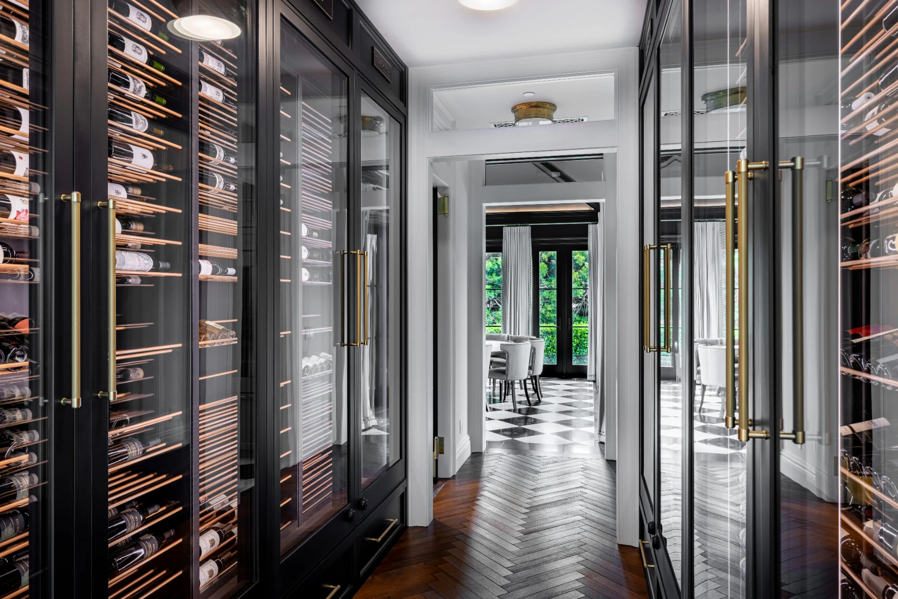 Finished La Jolla hallway wine cellar with opposing glass doors