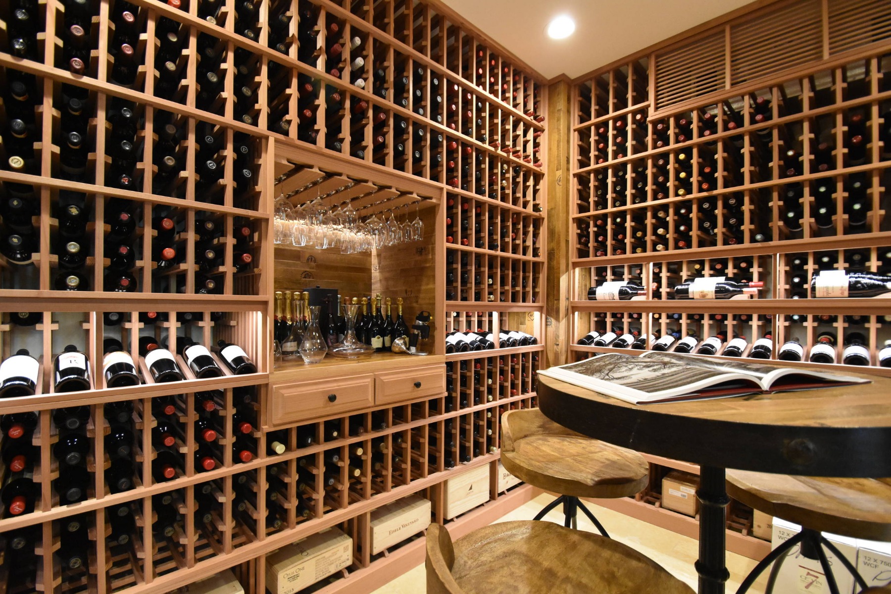 Custom wine cellar incorporates wine case storage throughout