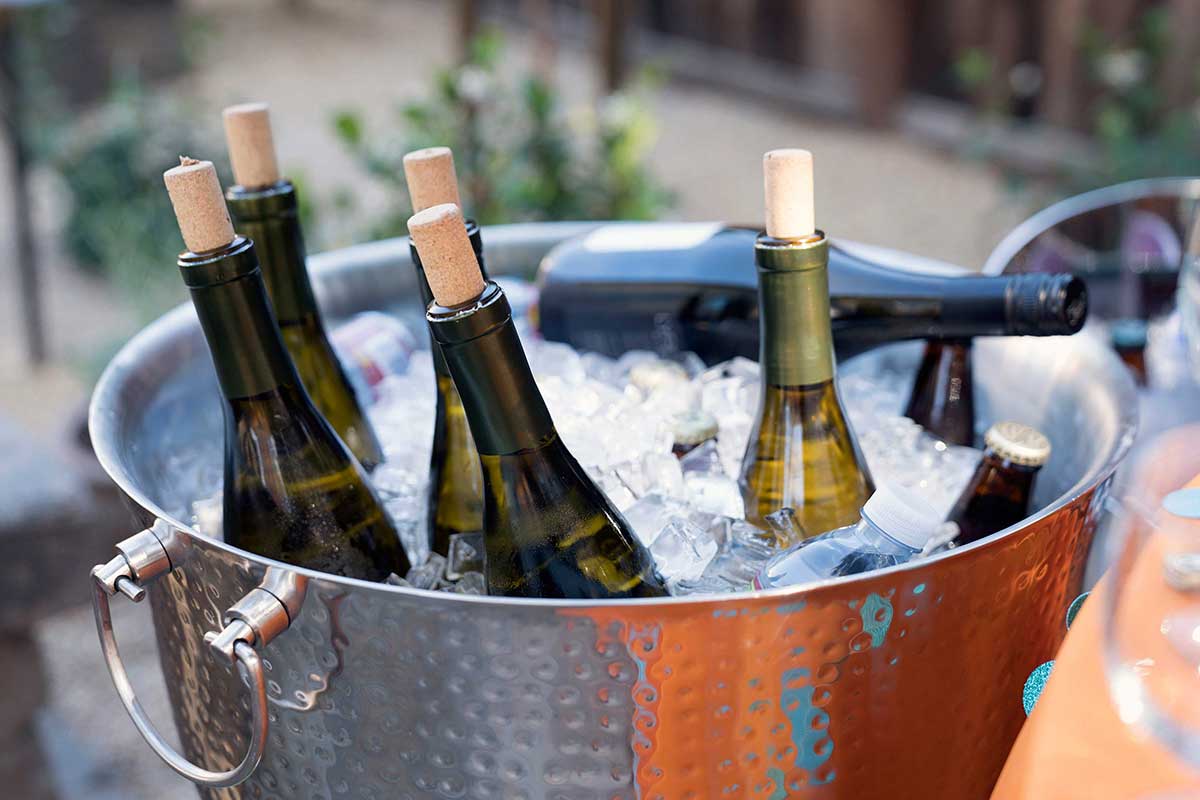 White wine being put in an ice bucket after opening