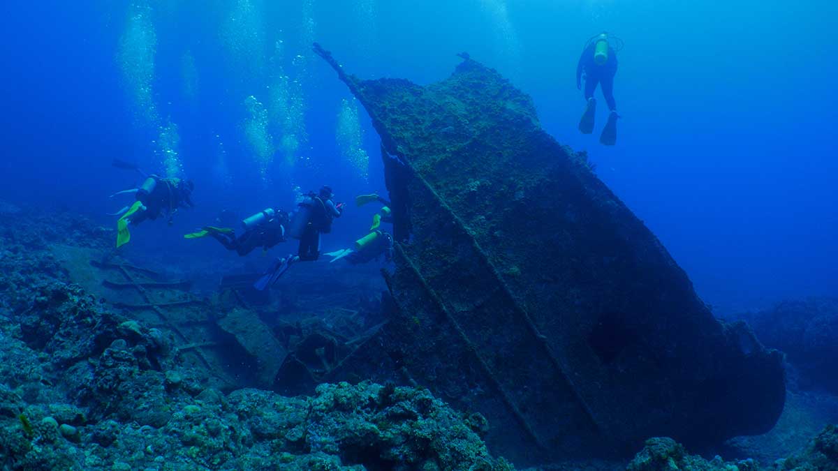 Scuba divers exploring sihpwreck